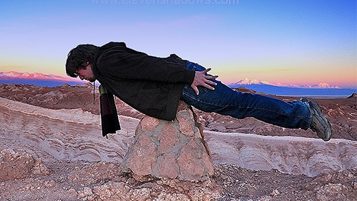 Picture of man balancing on a pile of rocks.