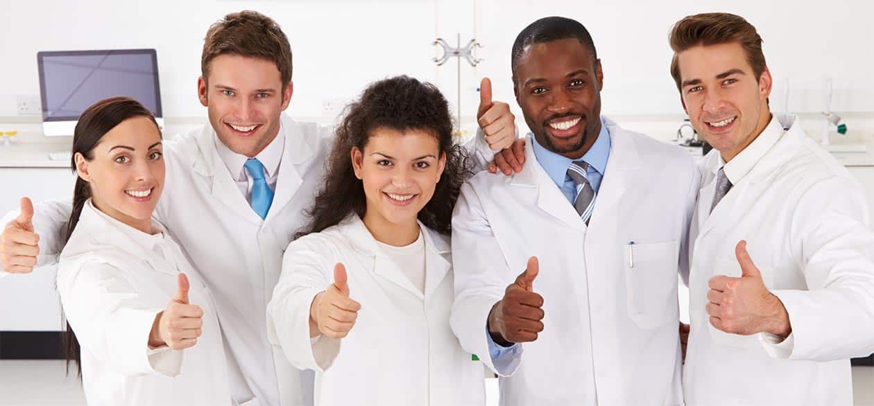 Photo of group of scientists with thumbs up.