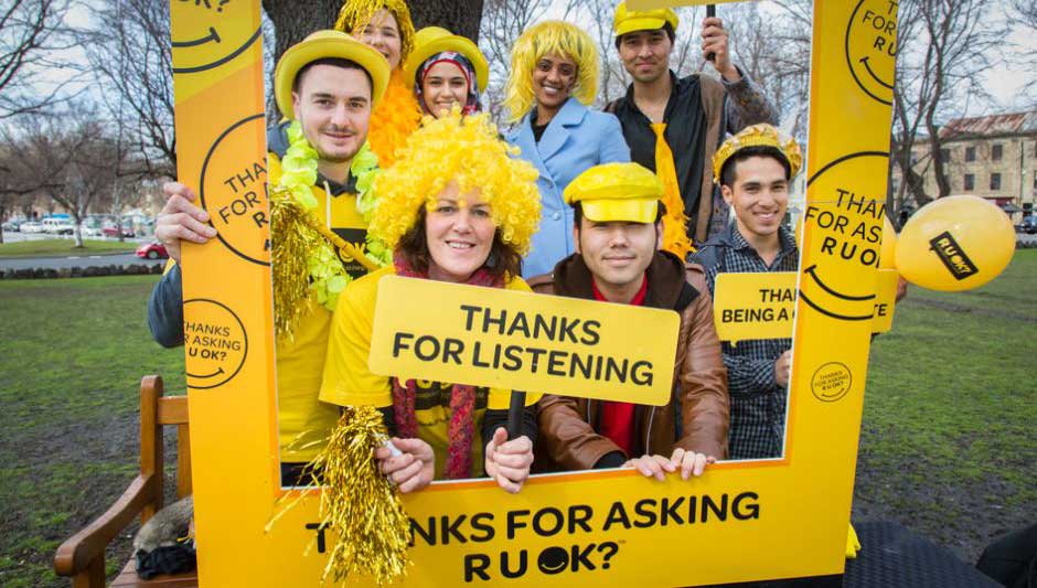 Photo of R U OK Group with banners and signs