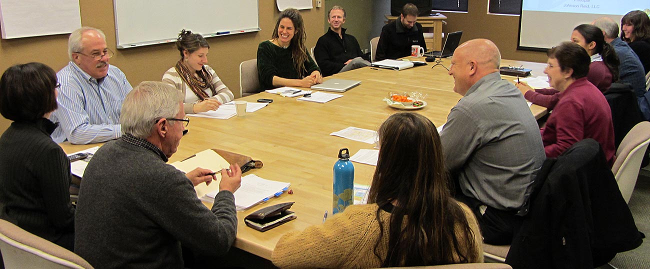 Photo of group of people in a meeting.