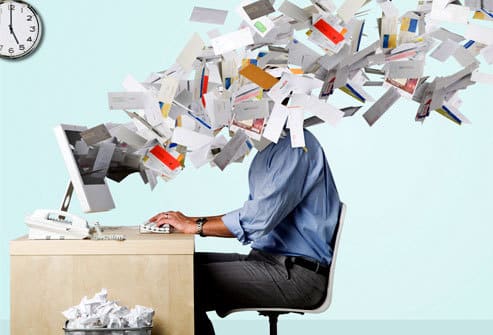 Picture of man overloaded with emails.